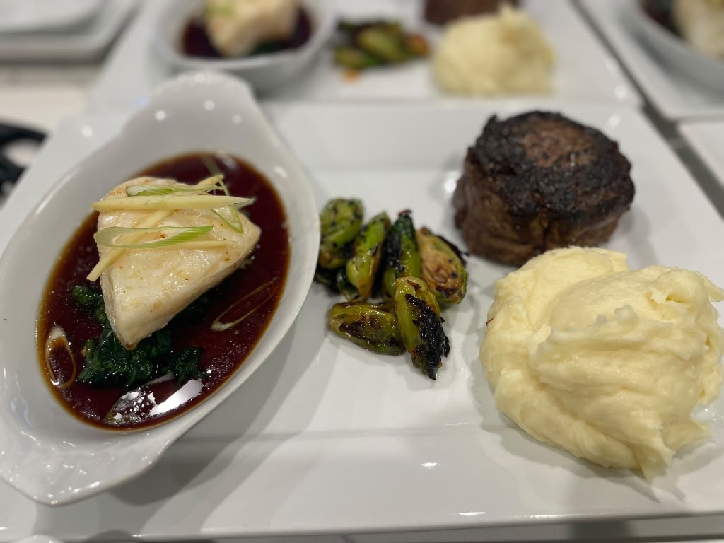 Plated filet mignon and miso halibut course